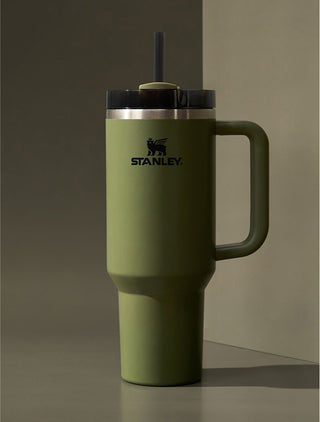 Stanley 1913 olive green insulated tumbler with handle and straw lid on a neutral green background